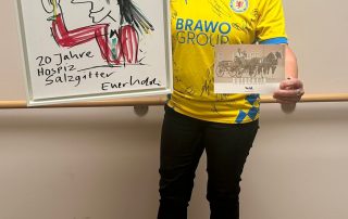 Geschäftsführerin vom Hospiz mit Gegenstände für die Versteigerung beim Benefizkonzert