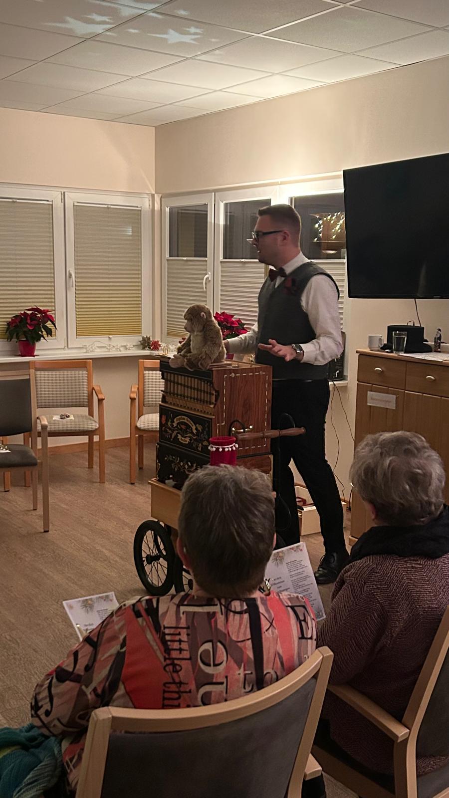 Mann steht an Drehorgel