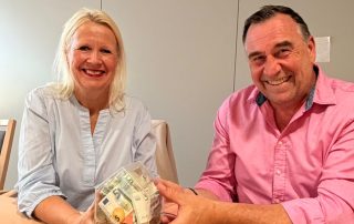 Bettina und Dirk Springer vom Burgfräulein halten ein Spendenhäuschen vom Hospiz in den Händen